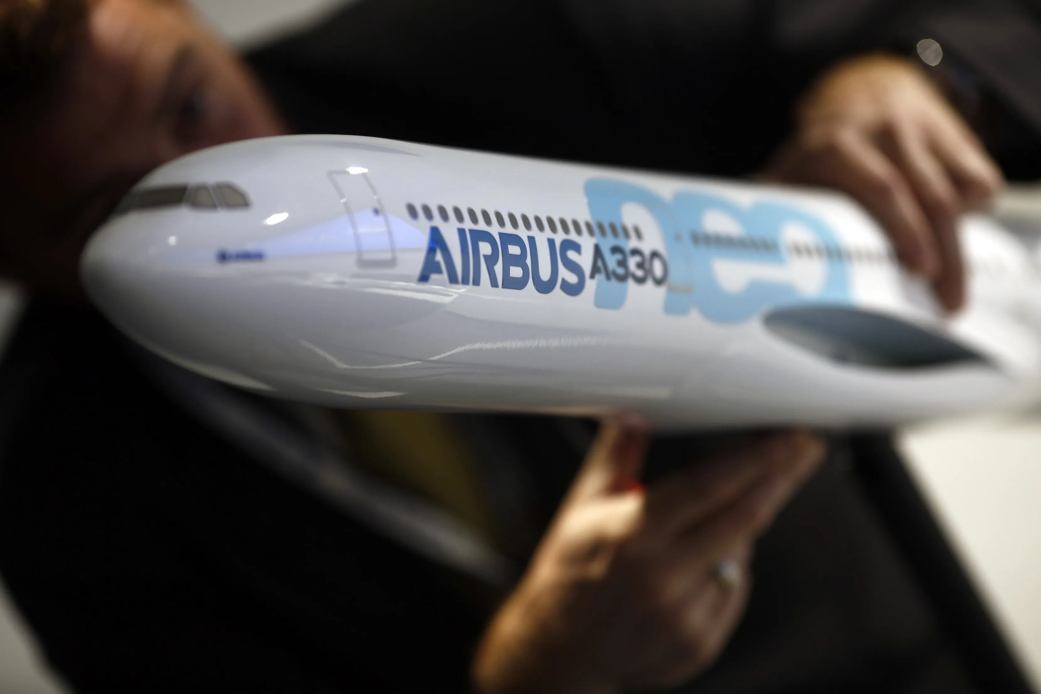 An employee assembles a model Airbus A330neo aircraft