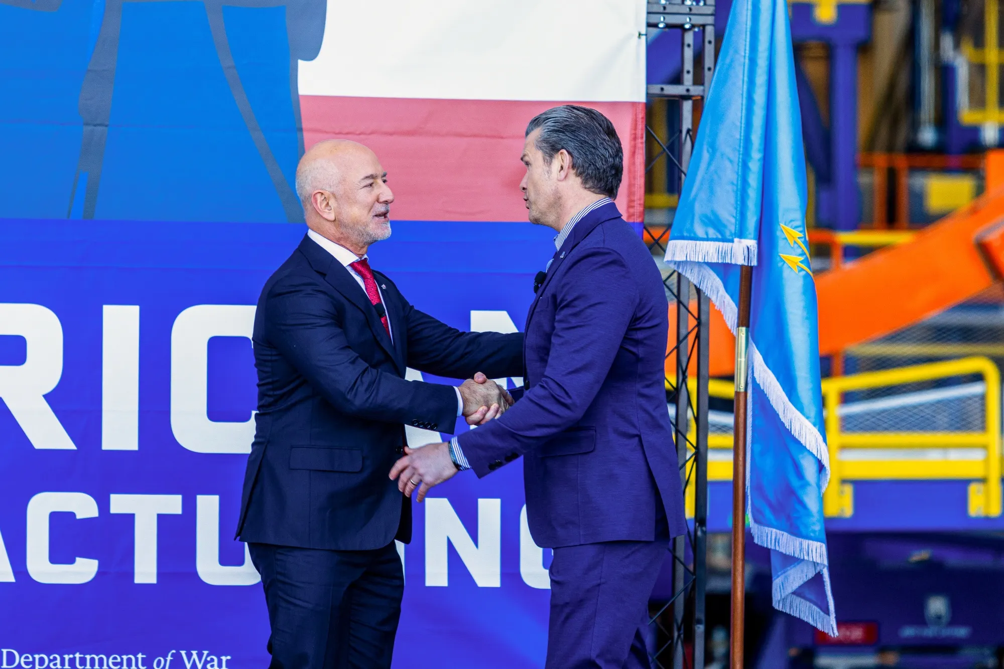 Jeff Bezos and Pete Hegseth shake hands at the Blue Origin manufacturing complex in Merritt Island, Florida on Feb. 2.