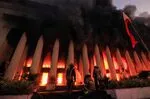 Firefighters douse a fire at the Post Office building in Manila on May 22.