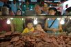 Two boys making funny faces in front of a 'bak kua', or barbecued meat counter in Singapore. 'Bak Kua' is a popular snack among ethnic Chinese during the Chinese New Year season in Singapore.
