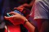 An attendee plays the Bethesda Softworks LLC Fallout: Shelter video game on a Nintendo Co. Switch.