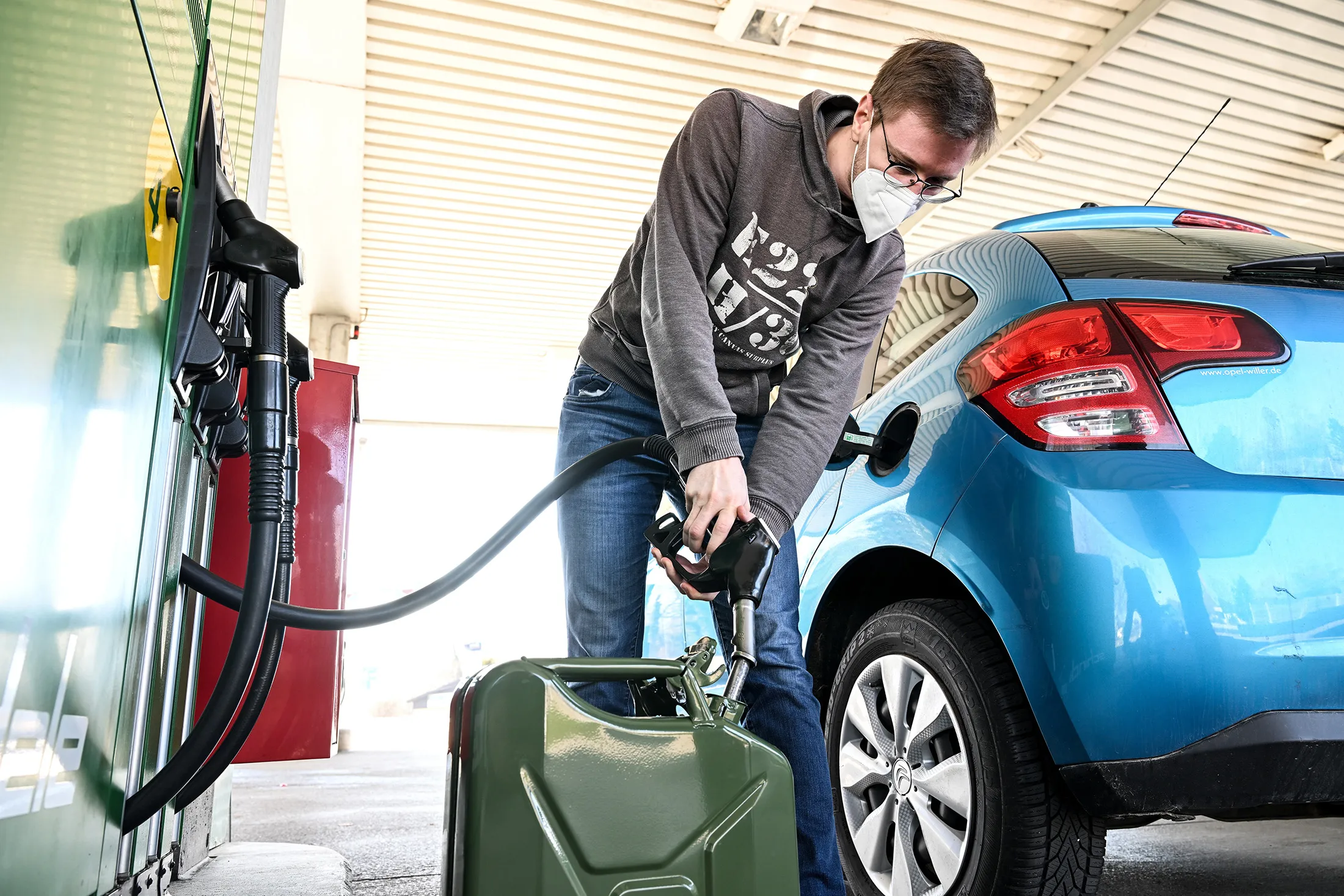 A customer fills up an extra canister at the Schindele service station in Hörbranz, Austria, on March 3.