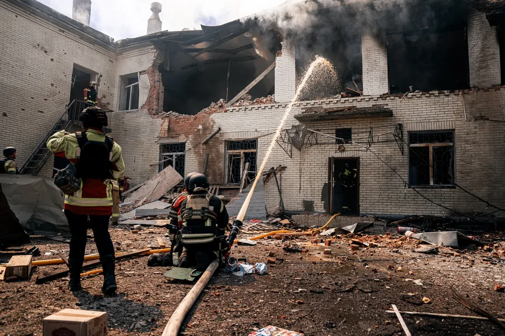 Firefighters work at the site of a drone strike on a school&nbsp;in Sumy, Ukraine on May 6.