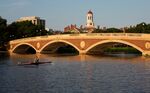 A sculler rows on the Charles River past the Harvard University Campus in Cambridge.
