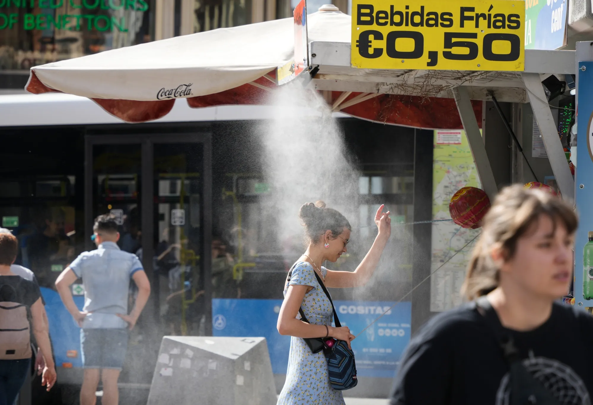A customer uses a cooling mist spray in Madrid, Spain.