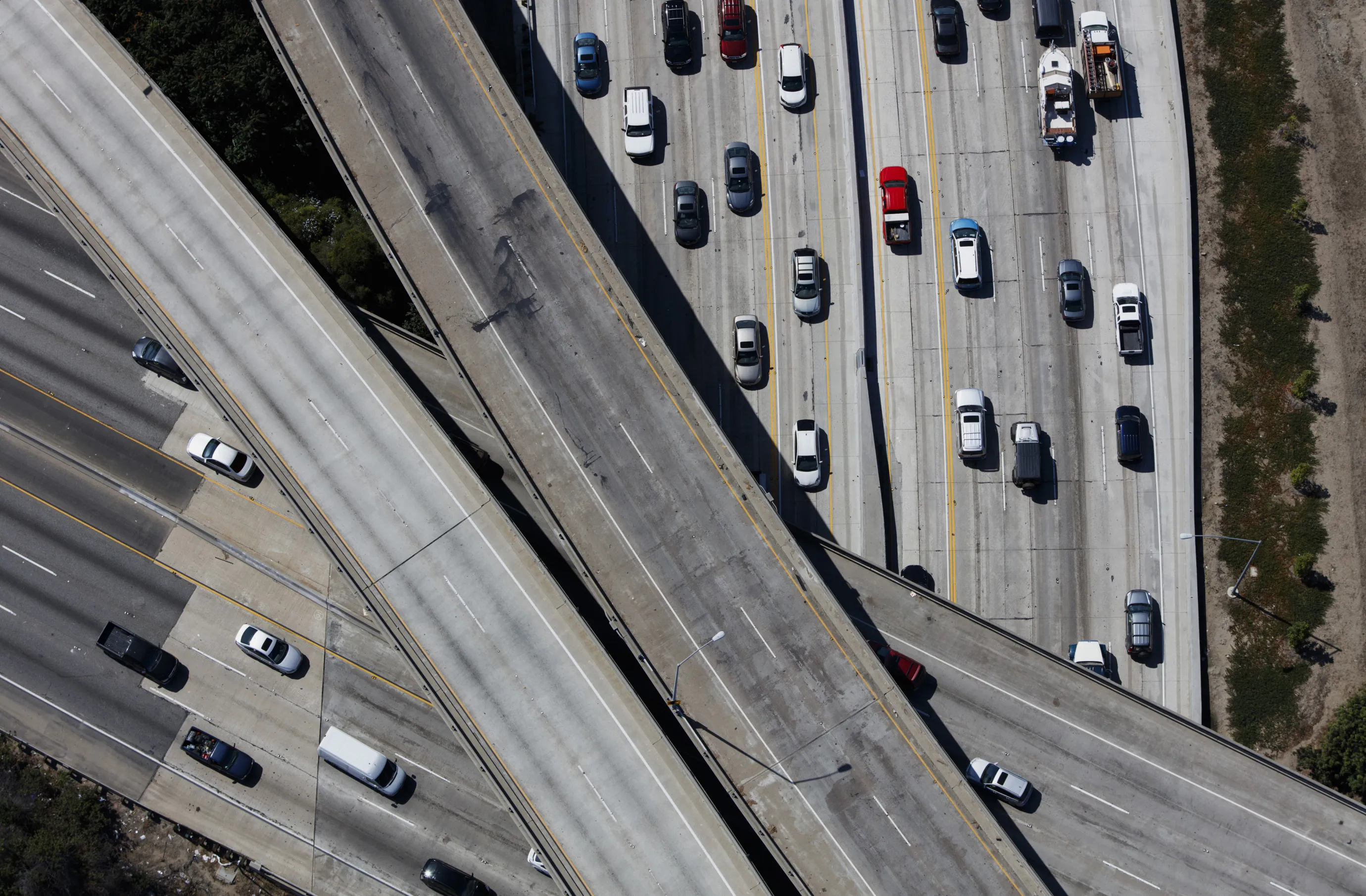 Vehicles move along the Interstate 405 freeway during rush hour in this aerial photograph taken over the Westwood neighborhood of Los Angeles, California, U.S., on Friday, July 10, 2015.&nbsp;