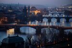 Electric street lamps illuminate bridges across the River Vltava early morning in Prague, Czech Republic, on Friday, Nov. 28, 2025. Czech economic growth accelerated more than expected in the third quarter, adding to reasons for the central bank to maintain tight monetary policy.