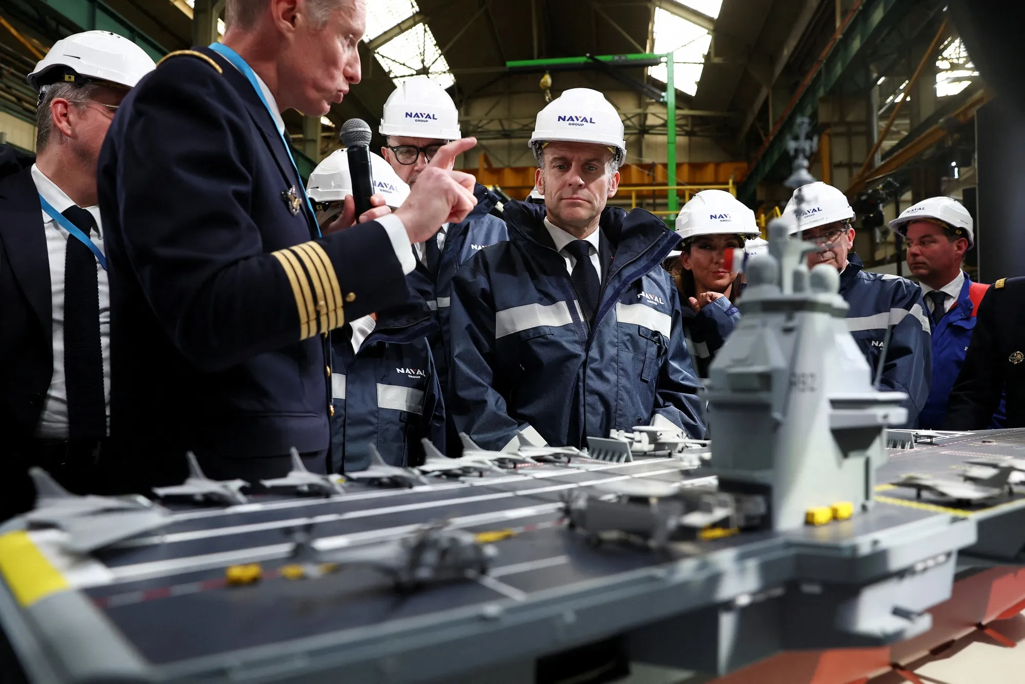 Emmanuel Macron looks at the model of a ship named “France Libre” during a visit to Naval Group Nantes-Indret, on March 18.