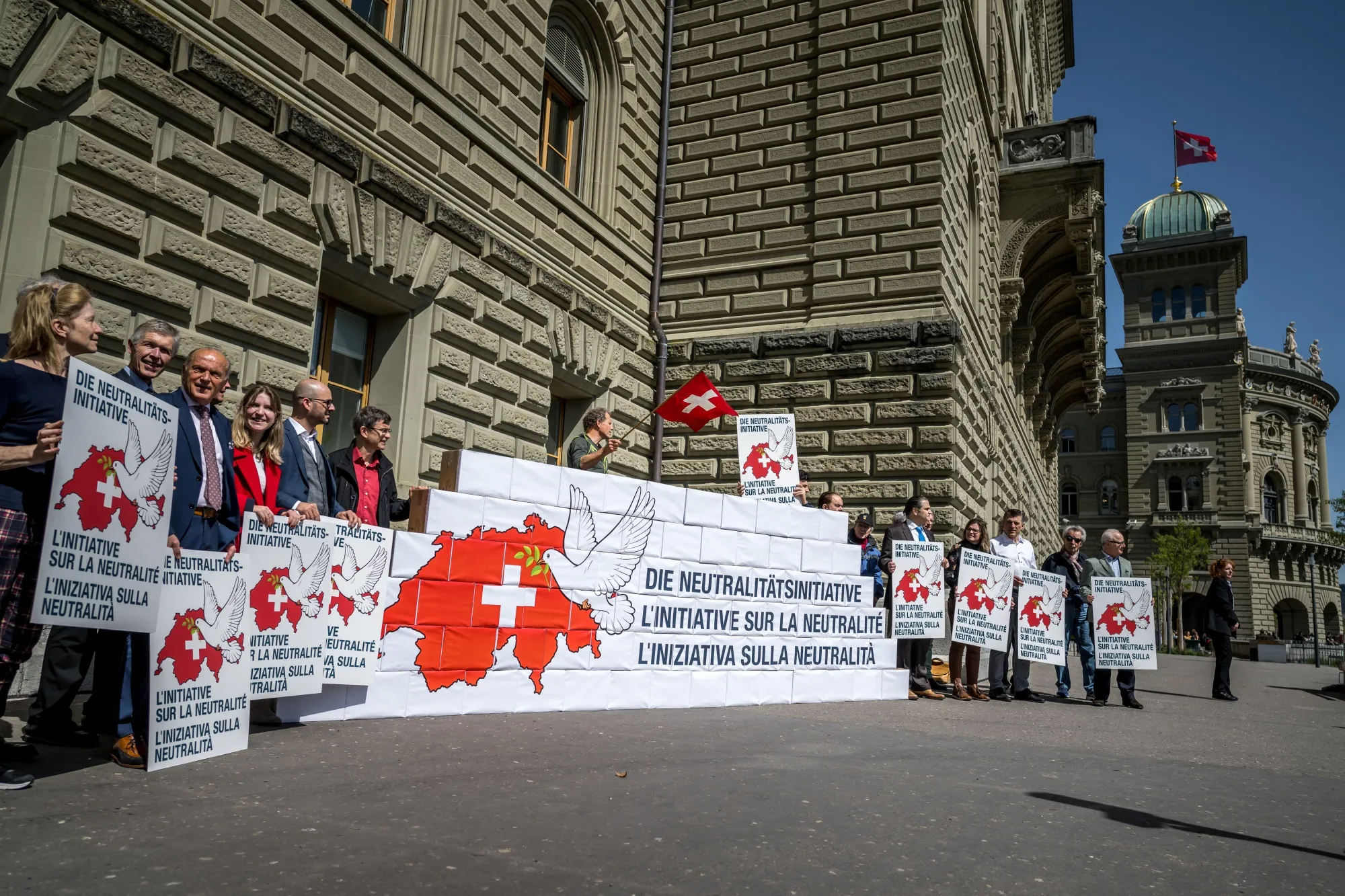 Supporters handing over&nbsp;140,000 citizen signatures to the Swiss Chancellery of a popular initiative "neutrality initiative" aims to prohibit Switzerland from entering into defence alliances and participating in sanctions.
