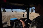 A tractor with a trailer that loads grain seeds from a combine harvester near&nbsp;Myronivka, Ukraine, July 29,&nbsp;