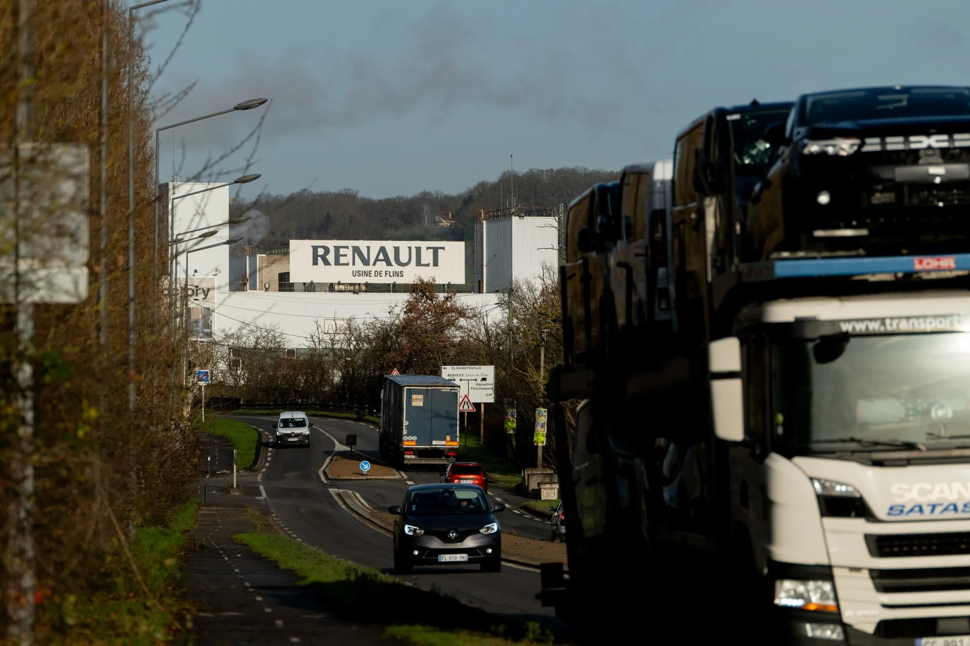 A vehicle transporter leaves the Renault automobile plant in Flins, France.