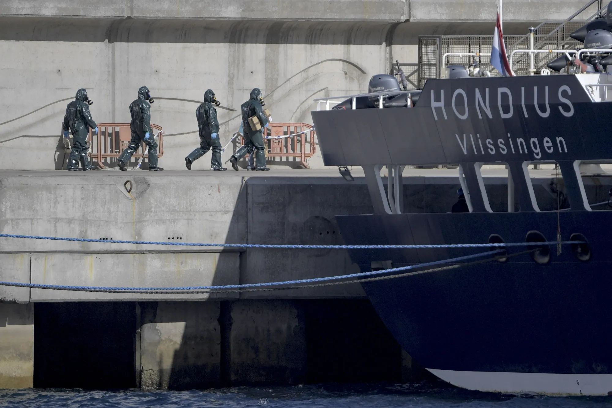 People wearing protective suits walk toward the hantavirus-stricken cruise ship MV Hondius&nbsp;in Tenerife, on May 11.