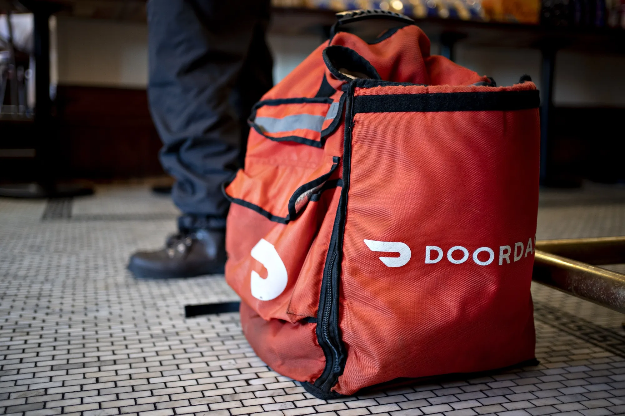 A DoorDash delivery person at a restaurant in Washington, DC.
