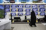 Customers browse televisions at a store in the Isfahan City Center shopping mall in Isfahan, Iran.