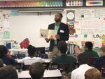 Financial planner Mac Gardner reads his book, “The Four Money Bears,”&nbsp;to children at an elementary school in Tampa, Florida, in November 2018.