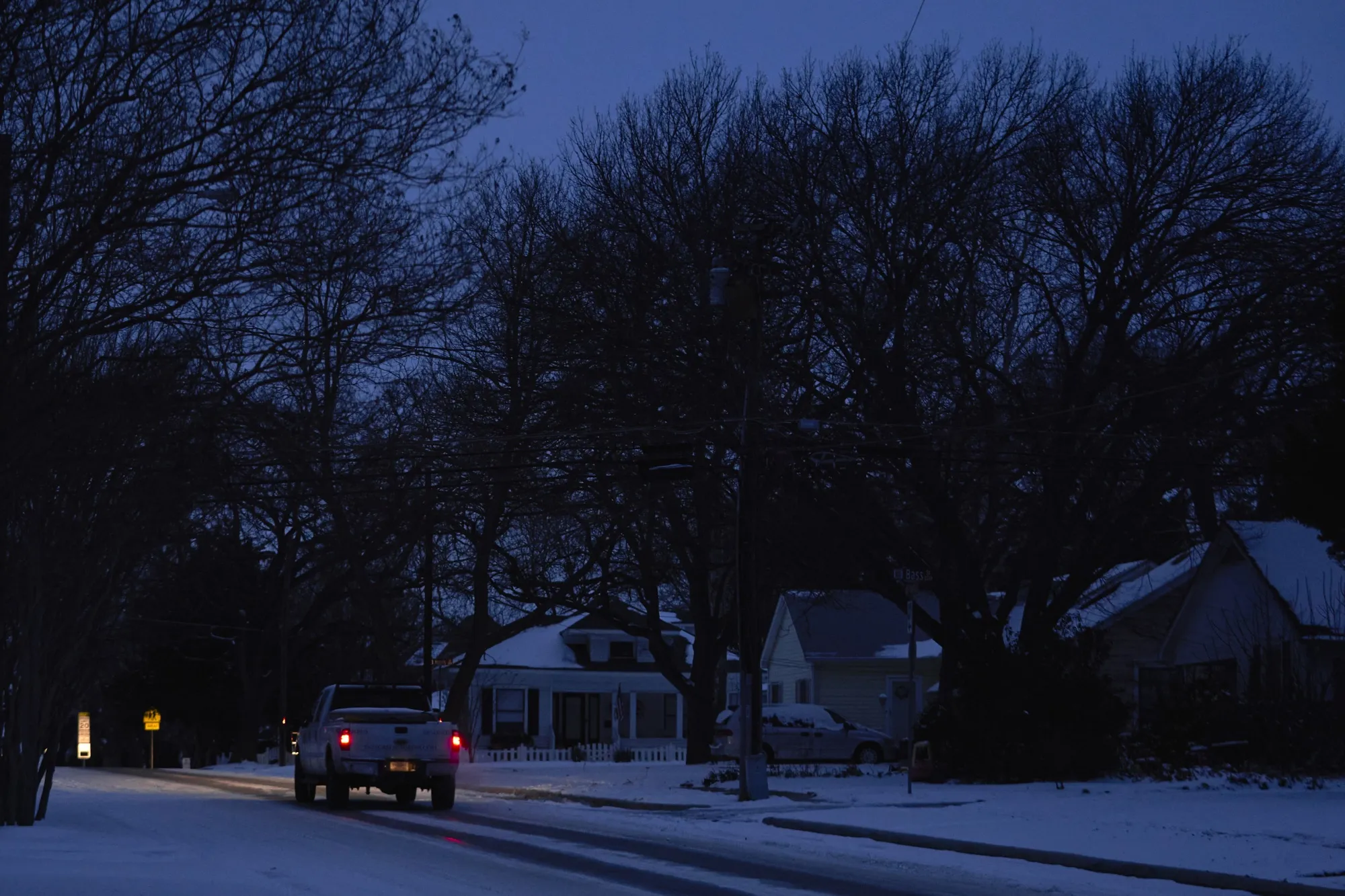 A truck drives down the street during a power outage in McKinney, Texas, on Feb. 16, 2021.