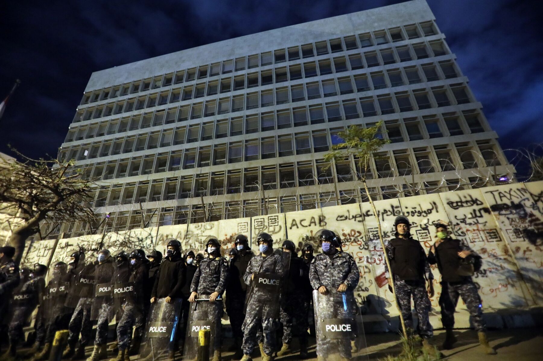 Police line up outside the headquarters of the Lebanese central bank during an anti-government demonstration in Beirut on April 28.