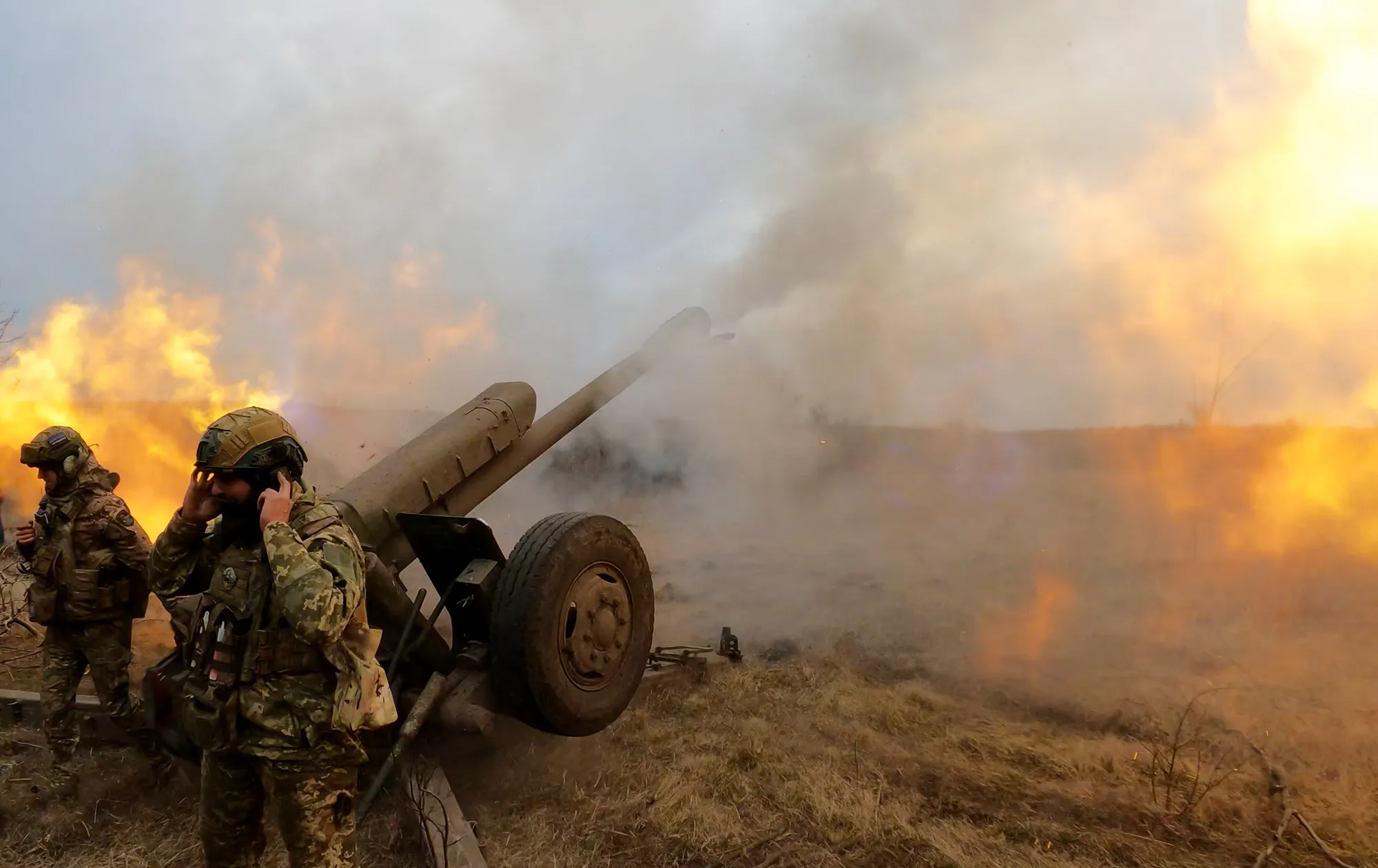 Ukrainian servicemen fire a howitzer at Russian positions near Bakhmut.