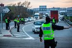 Members of the Mossos d'Esquadra police force direct drivers as they carry out controls to monitor access to only emergency or essential travel near Barcelona, Spain, on&nbsp;March 13.