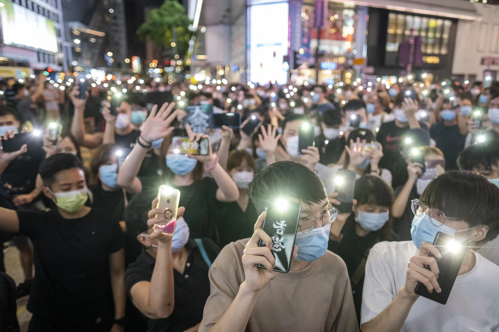 Demonstrators shine lights from their phones during a protest in Hong Kong on June 12.