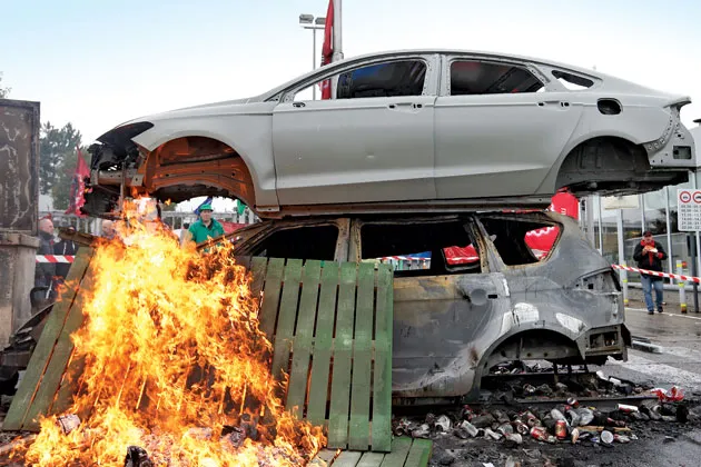 Workers at a Ford plant in Genk, Belgium, protest proposed layoffs