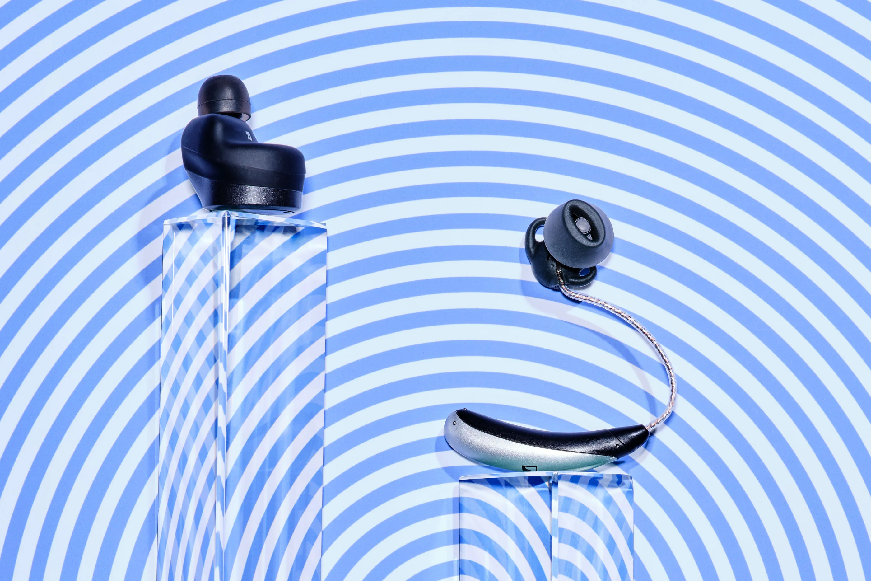 The HP Hearing Pro earbuds (left) and&nbsp;Sennheiser All-Day Clear Slim hearing aid.