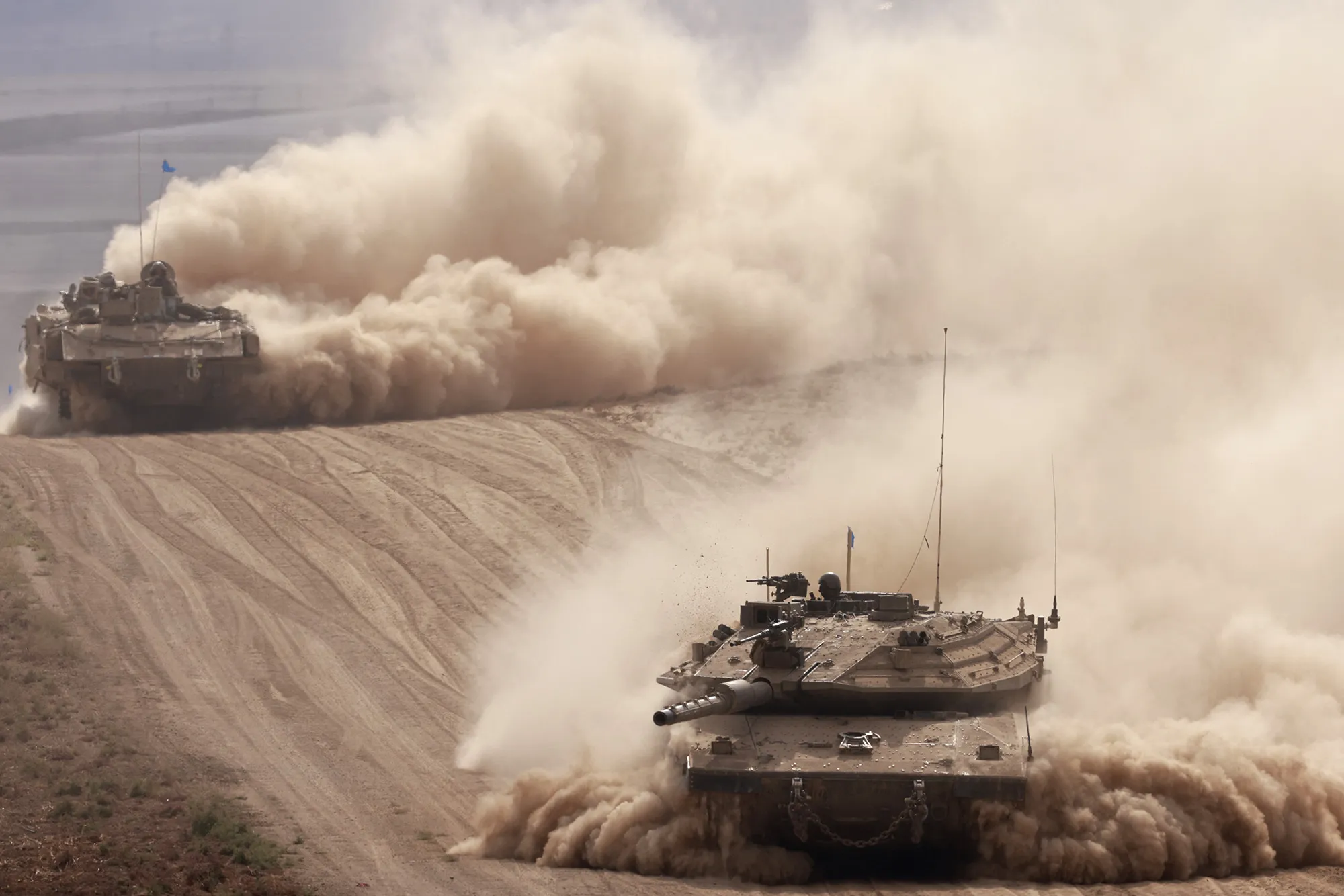Israeli army tanks drive in an area near Israel's southern border with Gaza on Oct. 6.