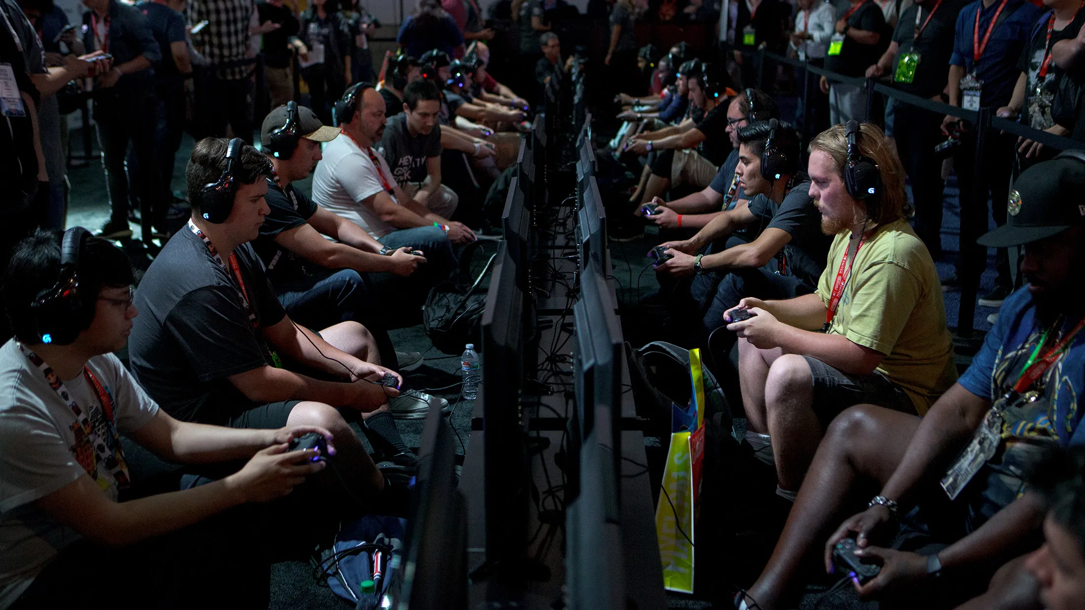 Attendees play the 'LawBreakers' video game by Nexon Co. during the E3 Electronic Entertainment Expo in Los Angeles, California, U.S., on Tuesday, June 13, 2017. For three days, leading-edge companies, groundbreaking new technologies and never-before-seen products is showcased at E3.

