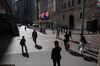 Pedestrians pass in front of the New York Stock Exchange (NYSE) in New York, U.S., on Friday, Oct. 2, 2020. New York faced pressure as middle and high schools reopened, infection rates in virus hot spots rose further and the city's bond rating was cut by Moody's.