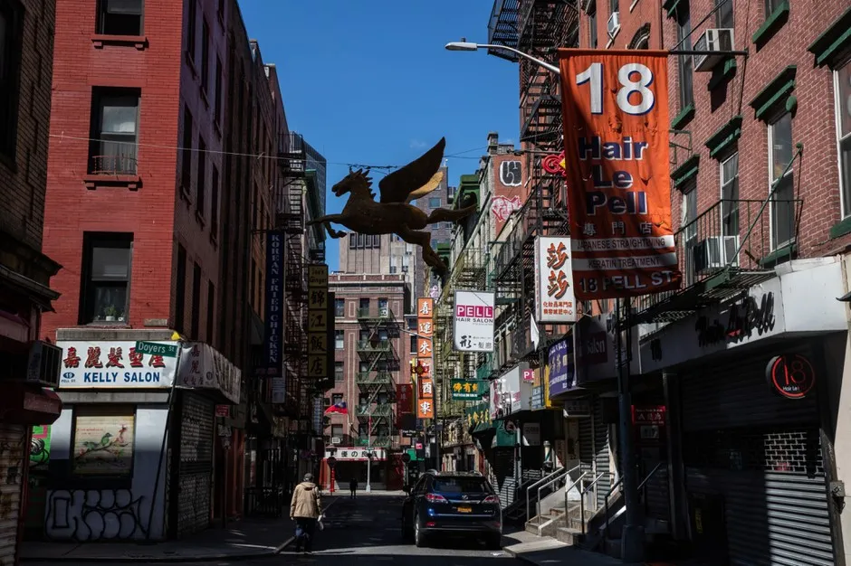 A pedestrian walks down a near-empty Doyers Street in Manhattan's Chinatown on April 6.