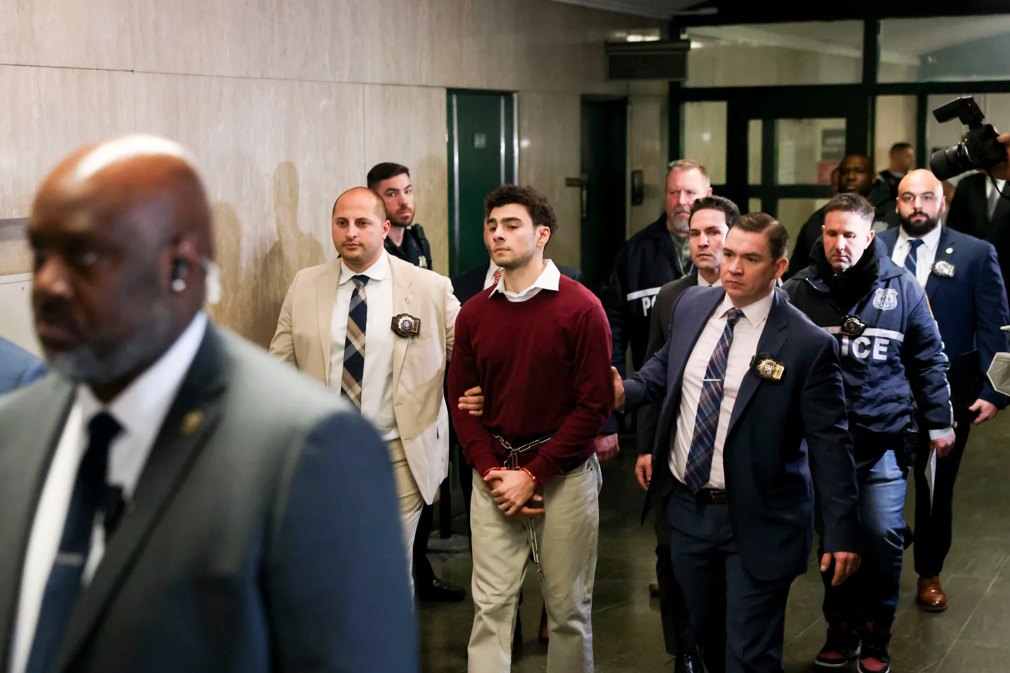 Luigi Mangione, the suspect in the killing of UnitedHealth Group Inc. chief executive officer Brian Thompson, center, exits New York State Supreme Court on Dec. 23.