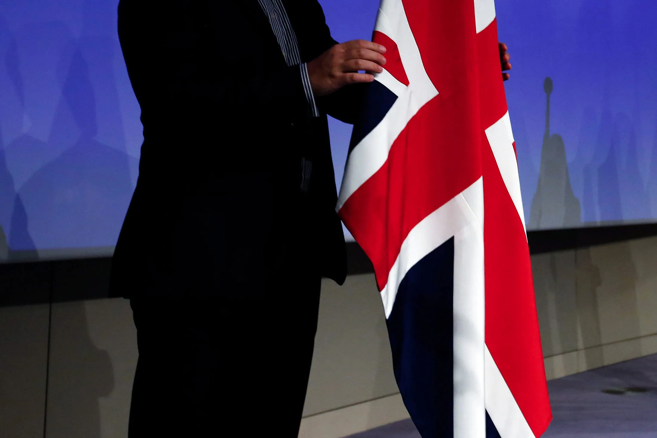 Employees arrange a British Union flag, also known as the Union Jack, left, and a European Union (EU) flag ahead of a news conference following the third round of Brexit talks in Brussels, Belgium, on Thursday, Aug. 31, 2017. European Union Brexit negotiator Michel Barnier said Brexit talks are “far” from making the progress that’s needed to move on to trade talks, as three days of negotiations produced few results.
