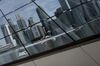 Commercial buildings in the central business district are reflected on a building facade in Singapore, on Monday, Dec. 9, 2013. Singapore\'s economy may expand 3.9 percent in 2014, according to a median of 21 economists and analysts in the Monetary Authority of Singapore\'s Dec. quarterly survey.
