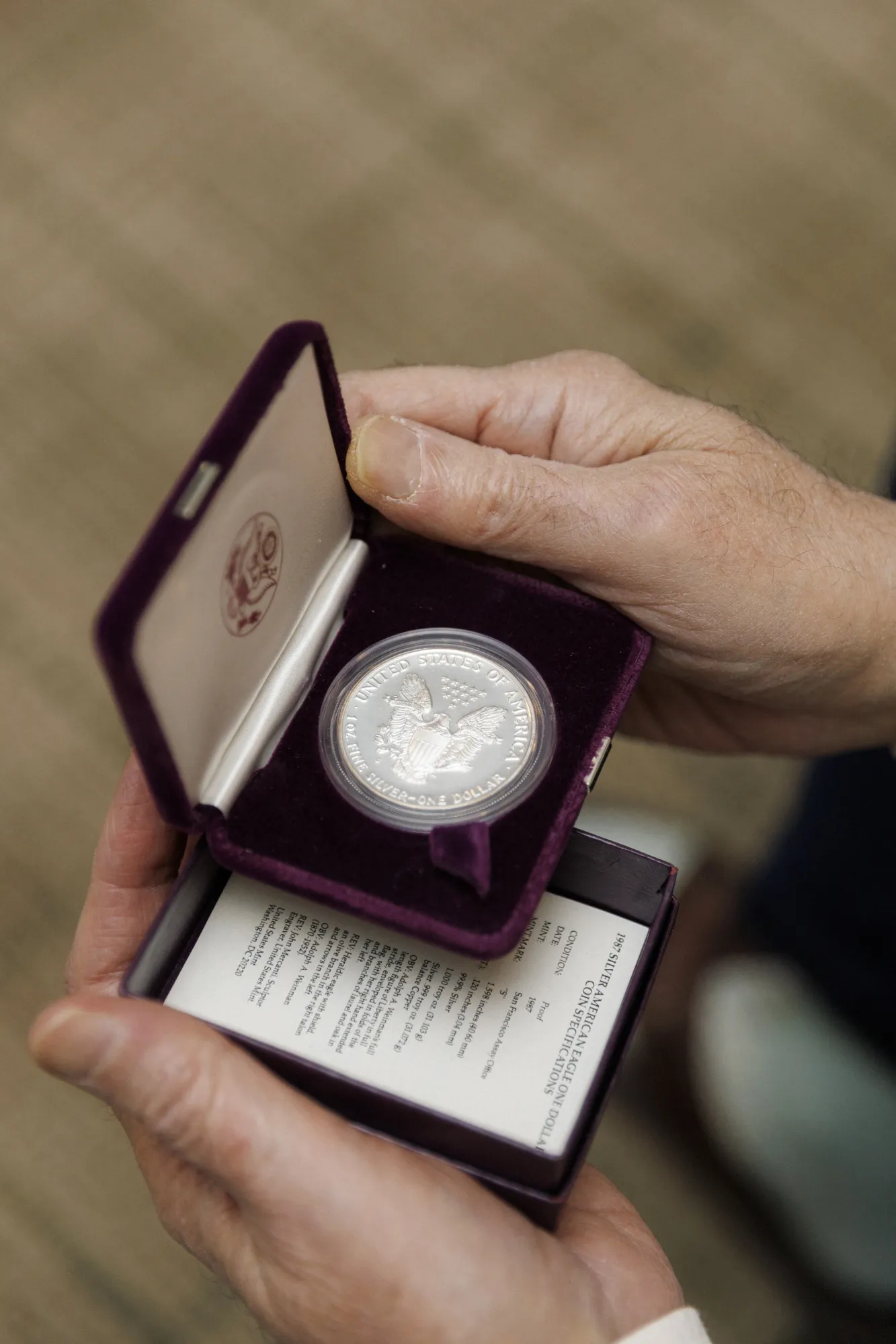 Sol Glatstein shows a coin from his silver collection in New York, US.