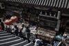 Pedestrians walk through a market street in the Wangfujing district of Beijing.