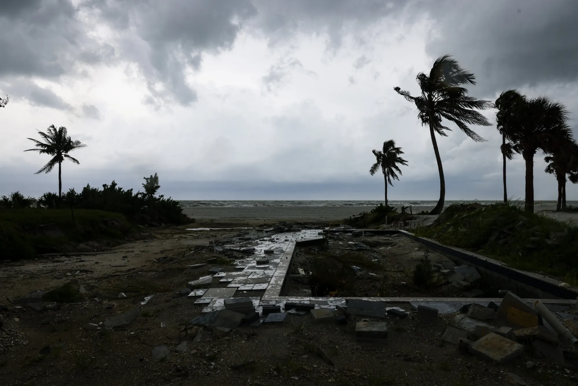 Debris fills&nbsp;a pool at a home damaged after Hurricane Ian in Fort Myers Beach.