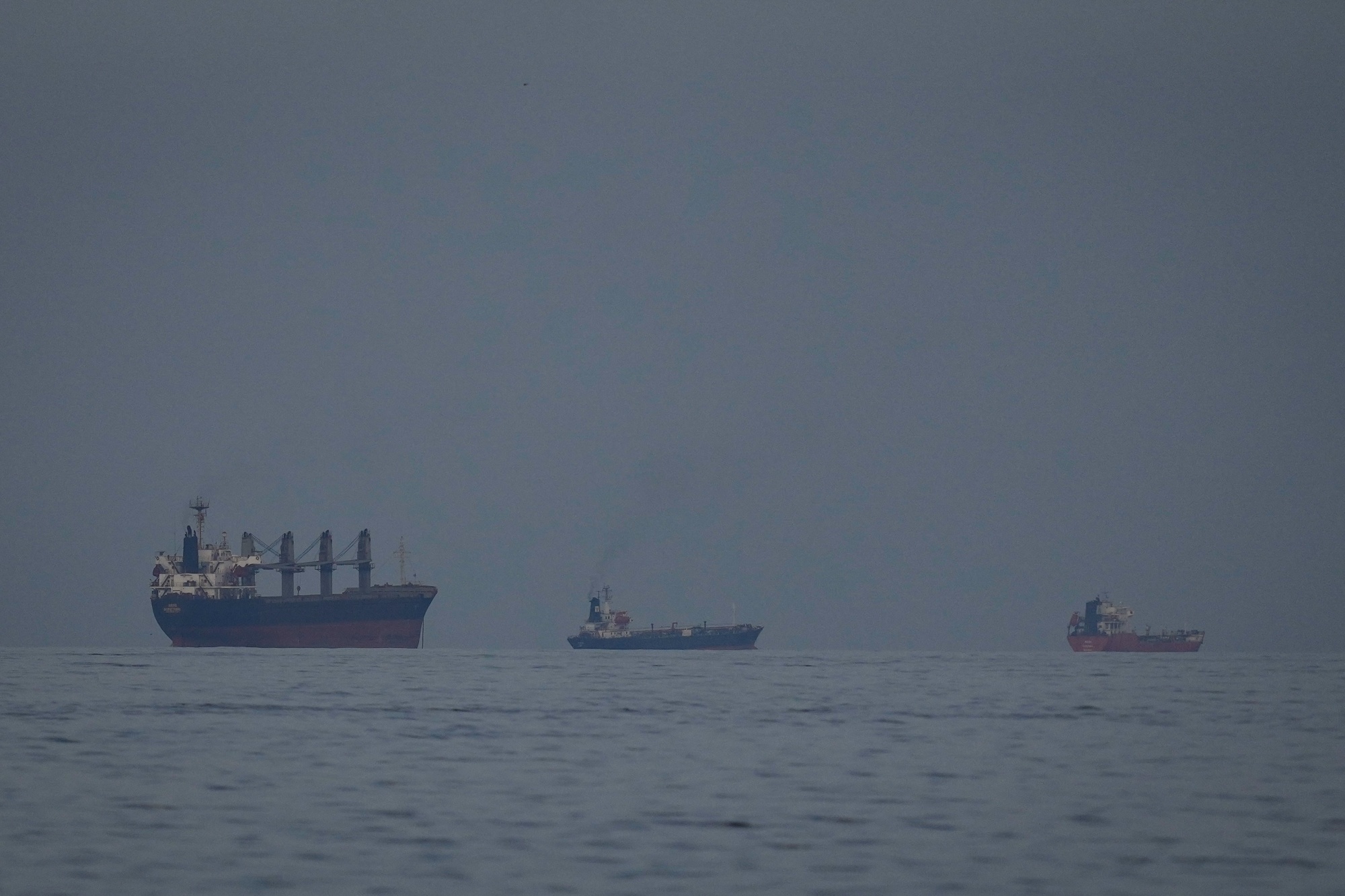 Oil tankers and ships line up in the Strait of Hormuz as seen from Khor Fakkan, United Arab Emirates on March 11. Photographer: Altaf Qadri/AP Photo