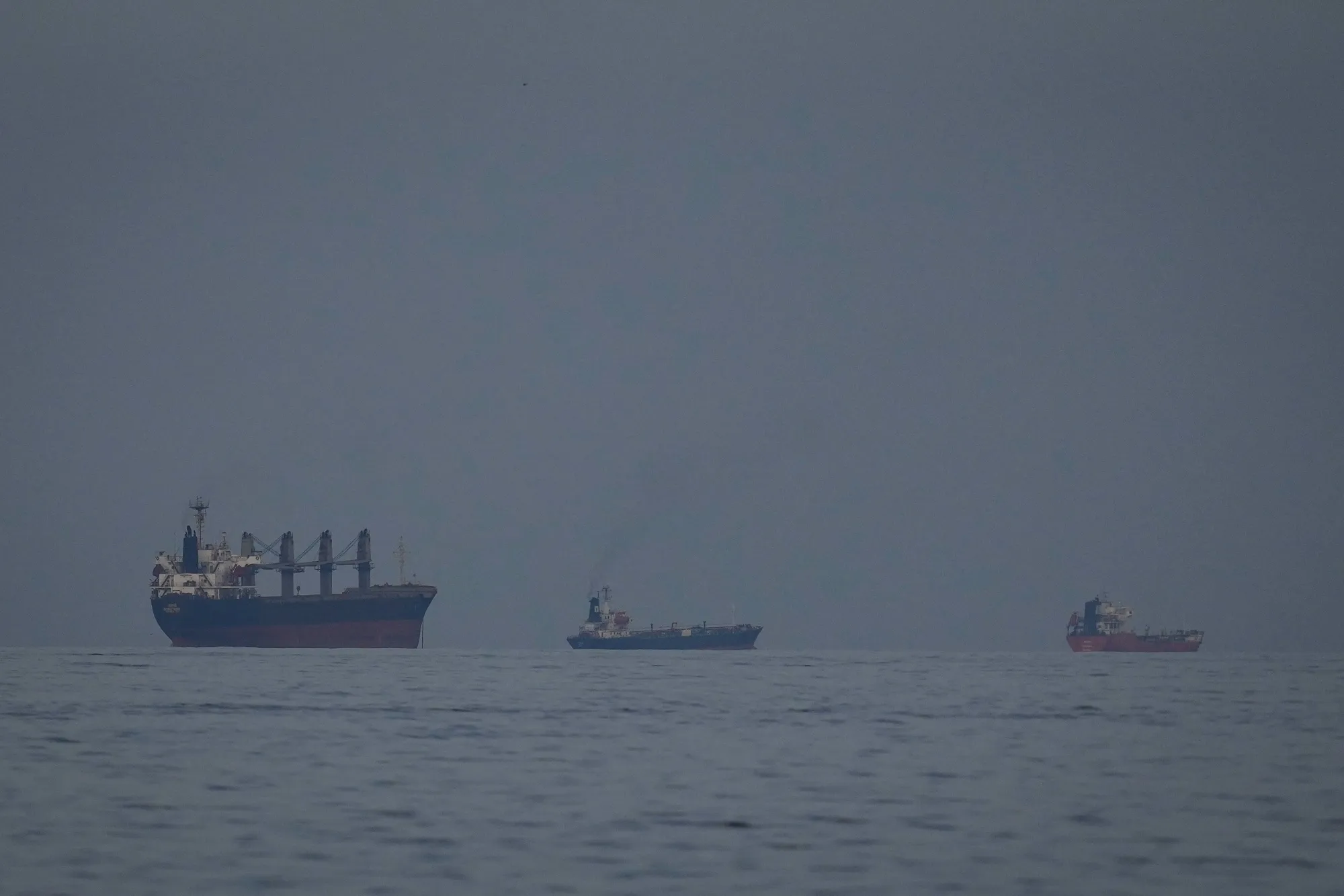 Oil tankers and ships line up in the Strait of Hormuz as seen from Khor Fakkan, United Arab Emirates on March 11.