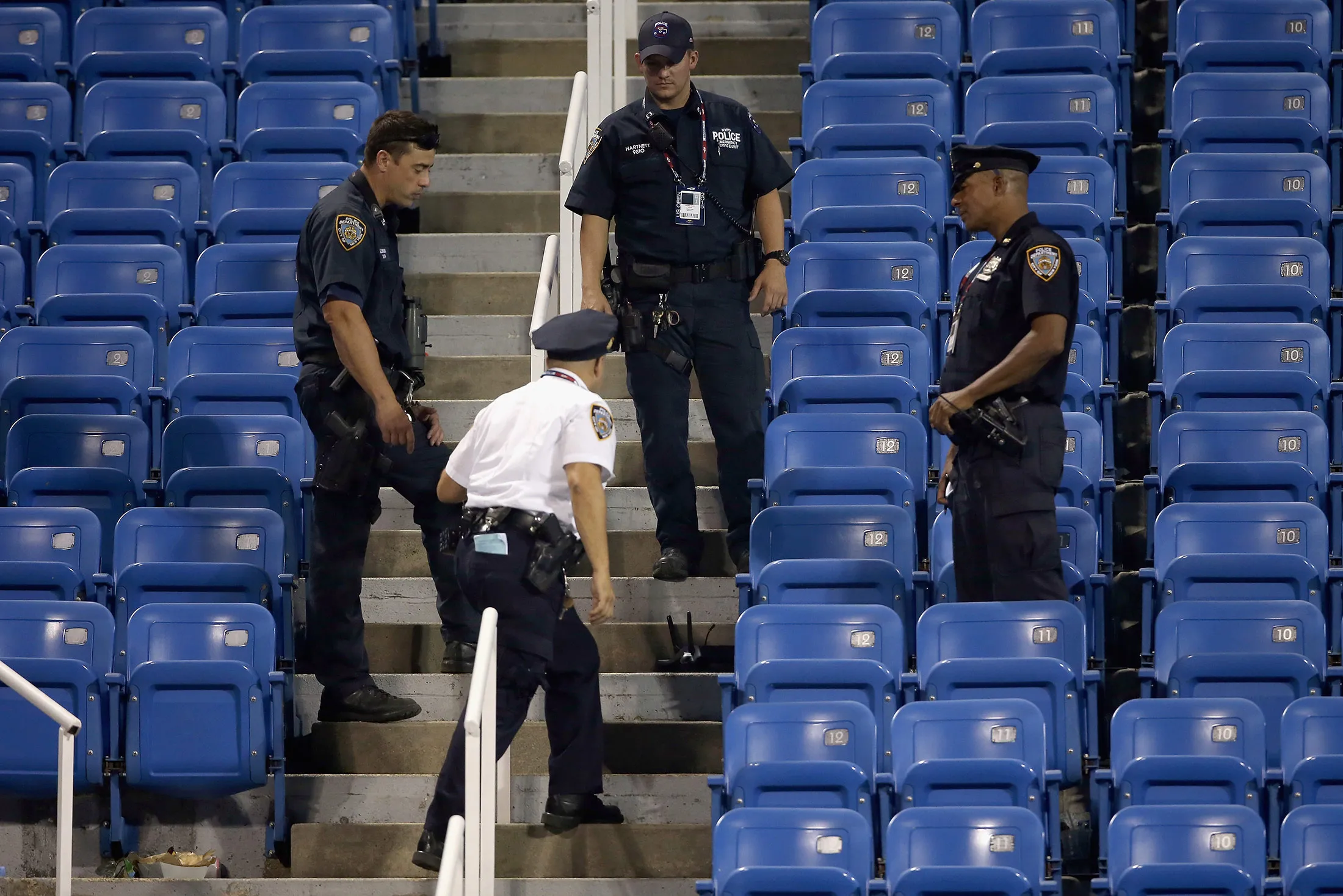 Police stand guard next to a drone after it crashed into the stands in Louis Armstrong Stadium during the during their Women's Singles Second Round match between on Day Four of the 2015 US Open, on Sept. 3, 2015 in Queens, NY.
