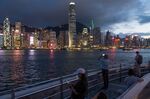 People use their smartphones along the Victoria Harbour waterfront in Tsim Sha Tsui district in Hong Kong.