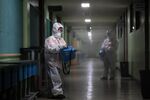 Workers disinfecting a high school in Anyang, South Korea, in Dec. 2020.&nbsp;In a world that’s trying to move on from the virus, even as it still kills thousands of people a day, Korean officials are once again reviewing their approach, seeking insights for the next pandemic.
