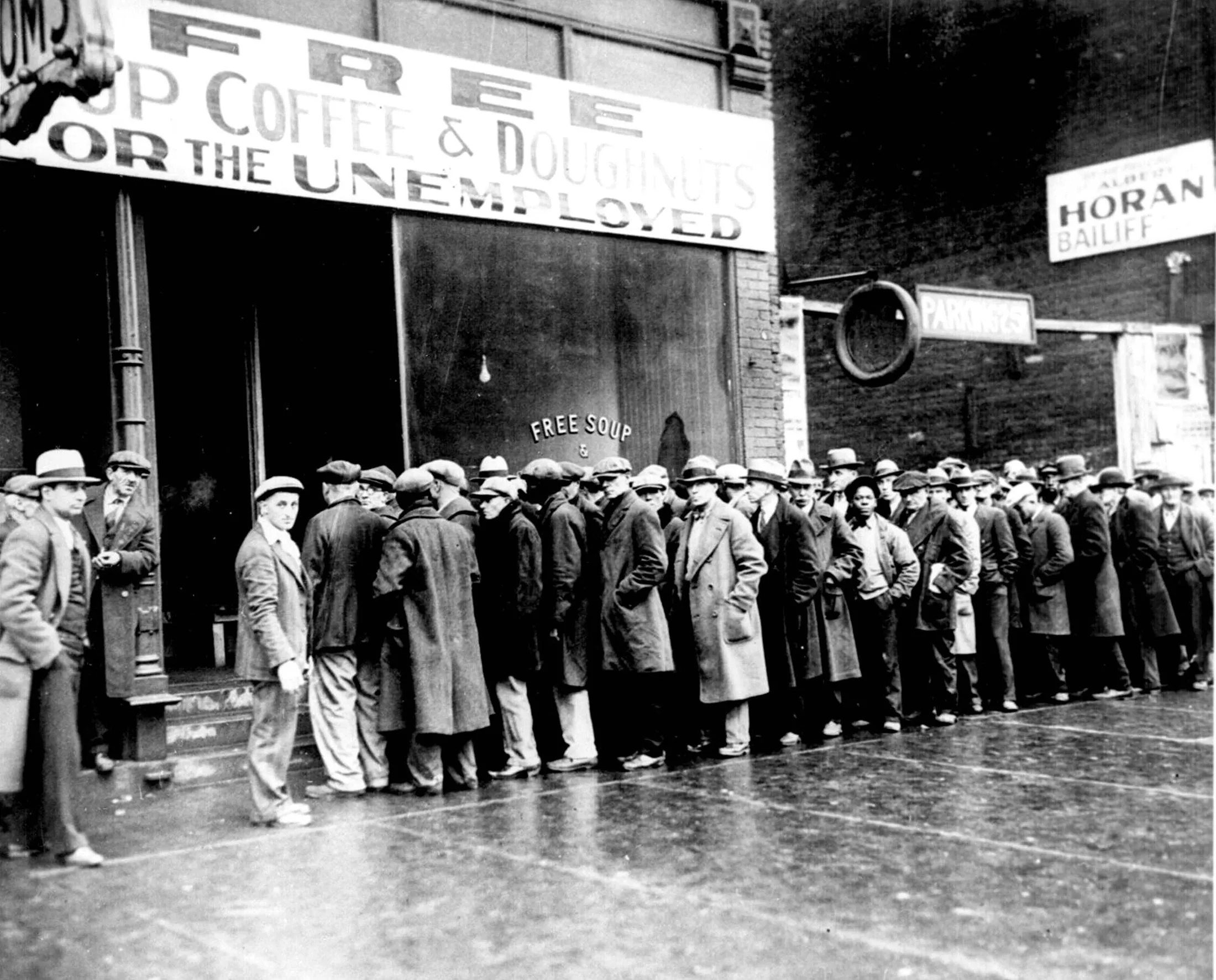 Unemployed line up outside a soup kitchen in New York during the Great Depression.