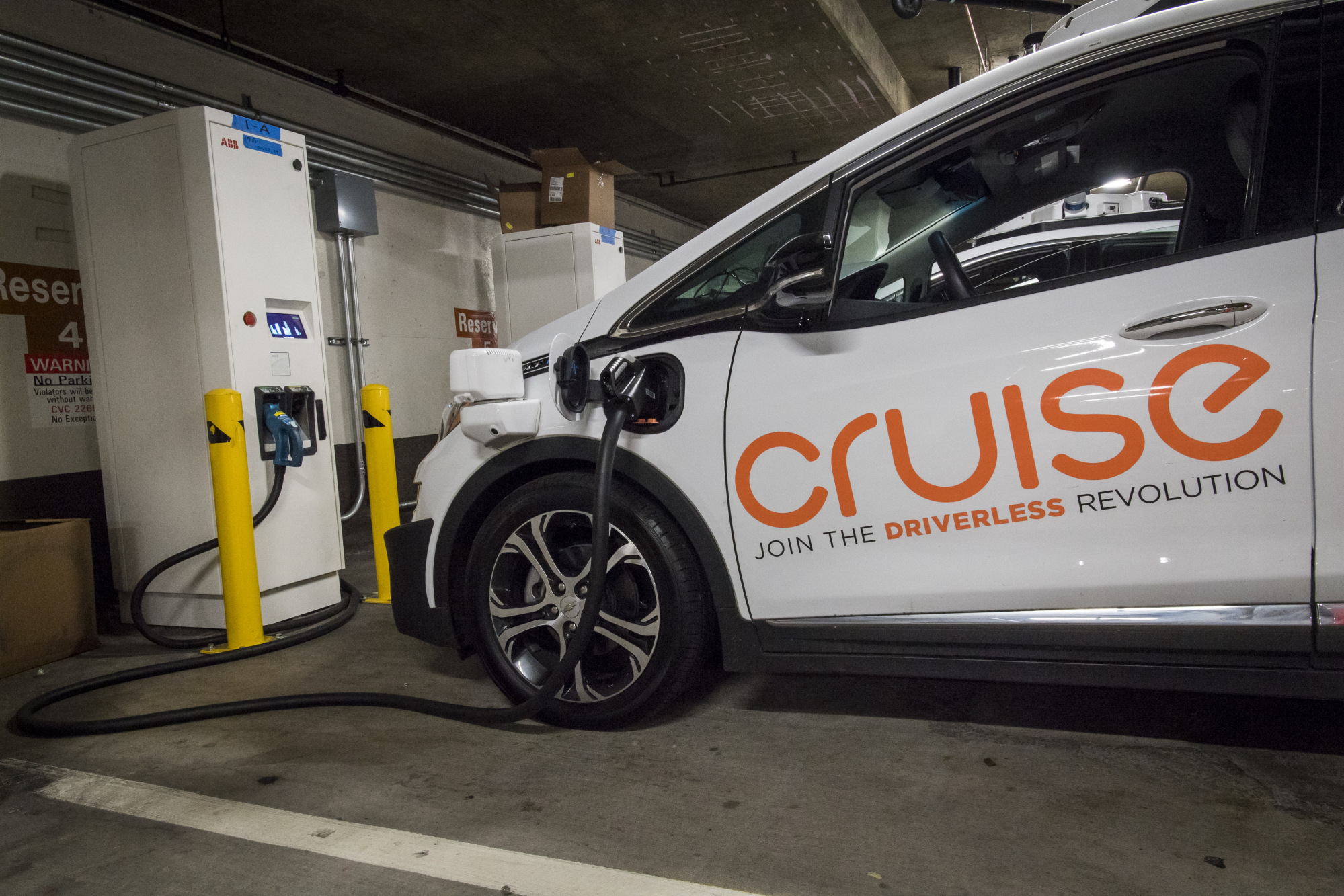 A Cruise autonomous test vehicle is parked at a charging station in San Francisco.