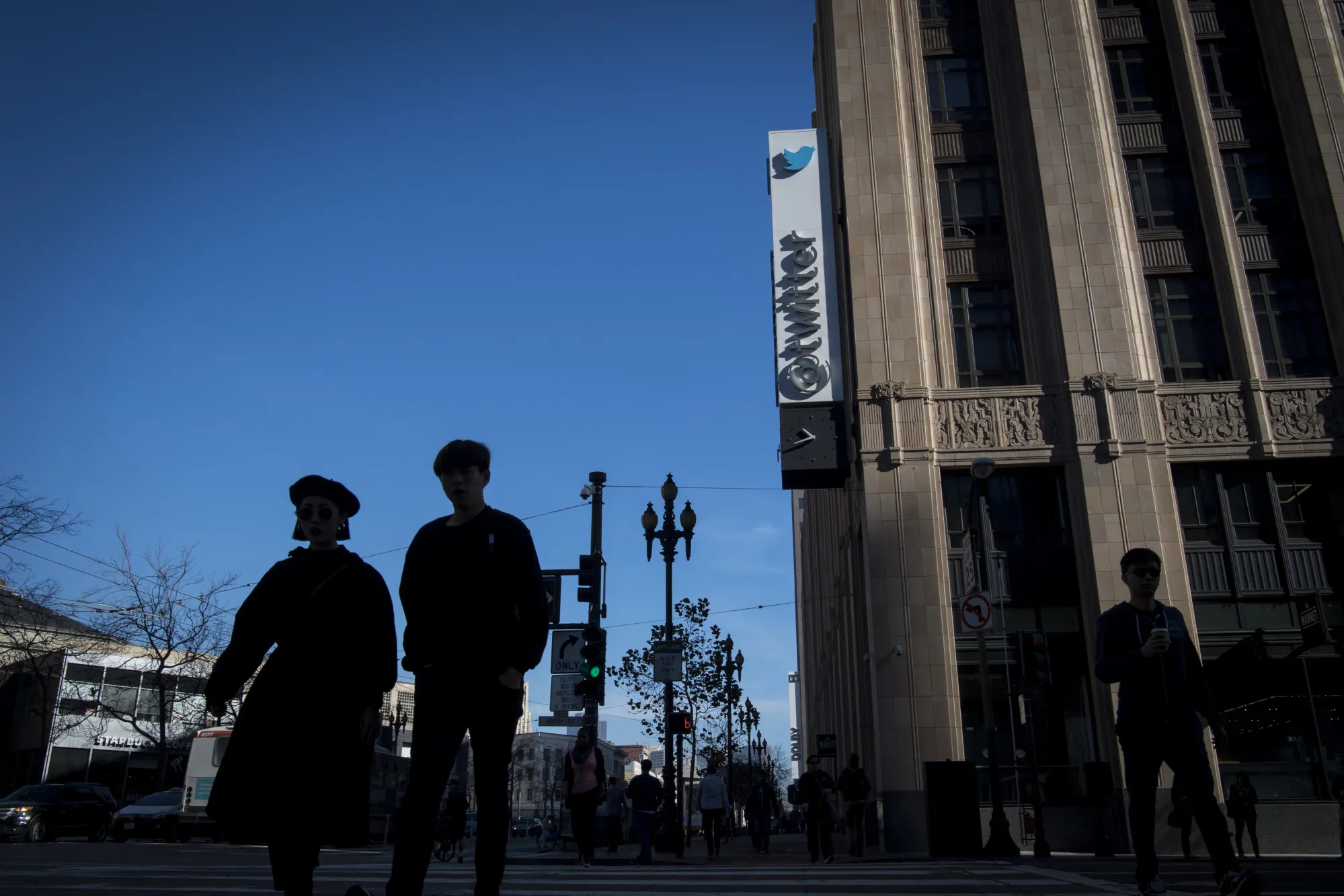 Pedestrians pass in front of Twitter headquarters in San Francisco.