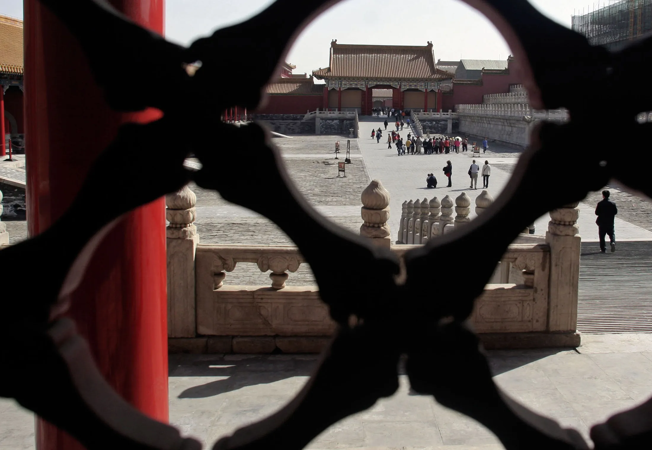 Tourists are seen through an ornamental gate at the Palace Museum, colloquially known as the Forbidden City, in Beijing.
