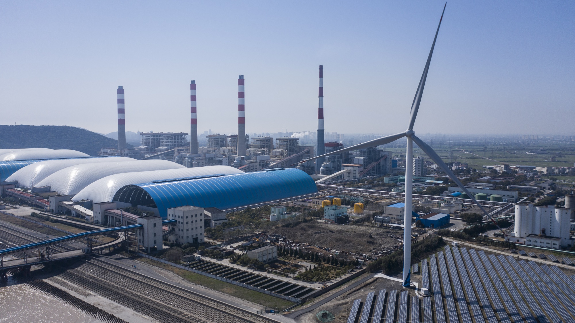 A solar farm next to a coal-fired power station in Jiaxing, China.