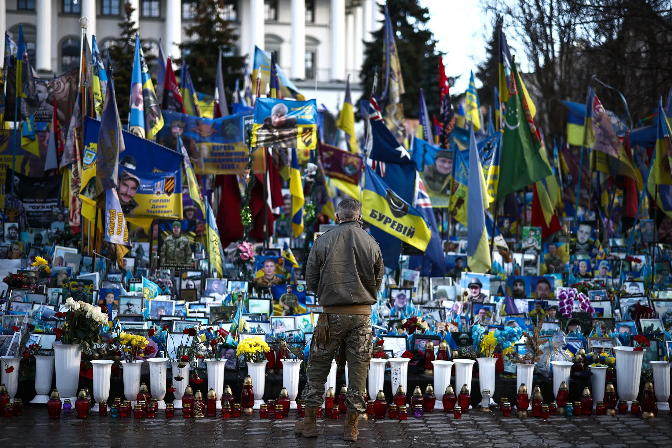 A member of the military visits a makeshift memorial to fallen Ukrainian and foreign soldiers at the Independence Square in Kyiv on March 2.