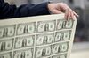 Steven Mnuchin, U.S. Treasury secretary, holds a 2017 50 subject uncut sheet of $1 dollar notes bearing Mnuchin's name at the U.S. Bureau of Engraving and Printing in Washington, D.C., U.S., on Wednesday, Nov. 15, 2017. A change in the Senate tax-overhaul plan that would expand a temporary income-tax break for partnerships, limited liability companies and other so-called "pass-through" businesses won the endorsement of a national small-business group today.