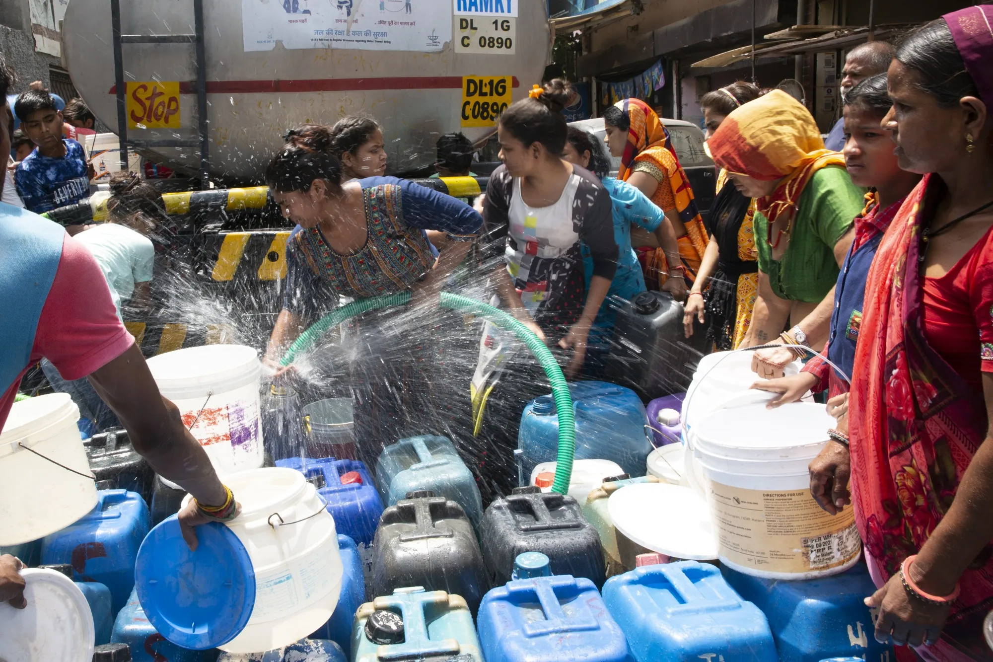 Residents fill water from a water tanker in Kusumpur Pahari slum in New Delhi, India, on Friday, May 13, 2022.&nbsp;