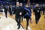 Duke head coach Mike Krzyzewski, left, walks off the court with his wife, Mickie, after Duke defeated Arkansas in a college basketball game in the Elite 8 round of the NCAA men's tournament in San Francisco, Saturday, March 26, 2022. (AP Photo/Marcio Jose Sanchez)